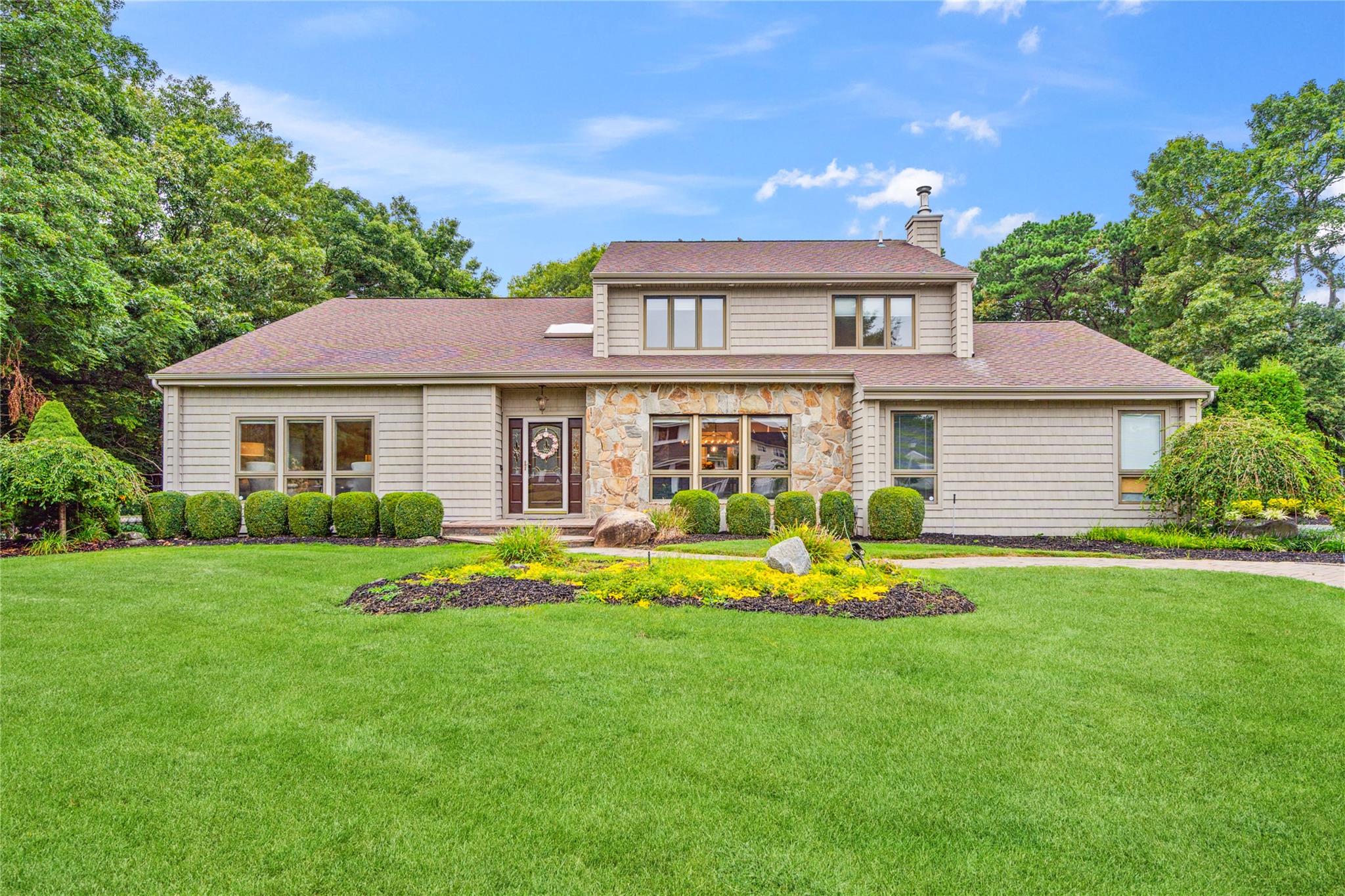 a front view of a house with a yard and porch