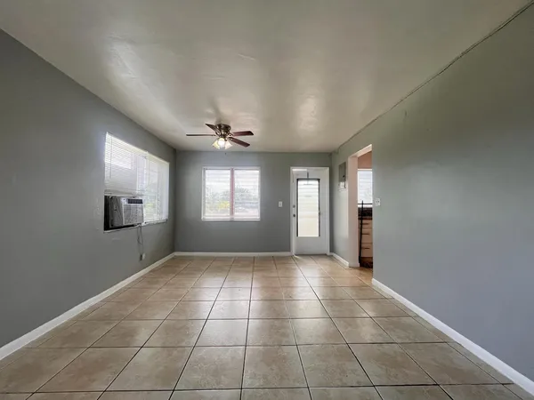 a view of an empty room and a window