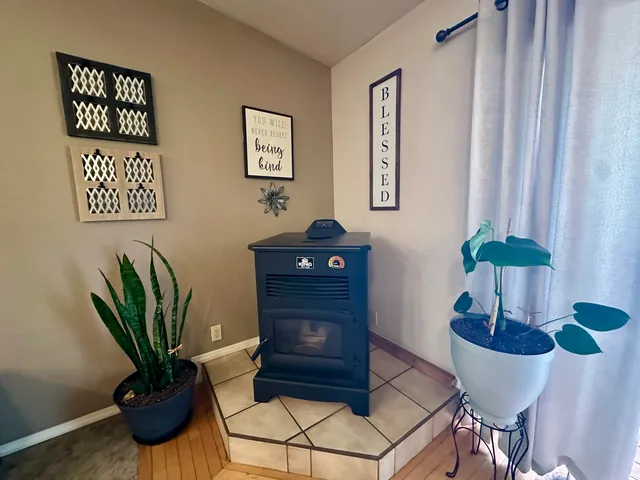 a large bedroom with wooden floor and furniture