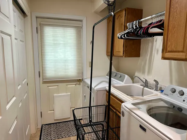 a view of a house with backyard and sitting area