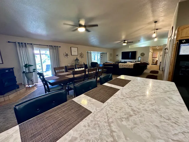 a kitchen with stainless steel appliances granite countertop a stove top oven a sink dishwasher and cabinets with wooden floor