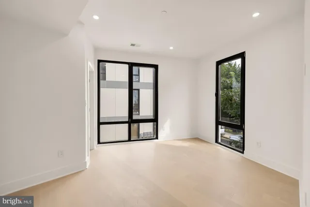 a bedroom with a bed and glass window