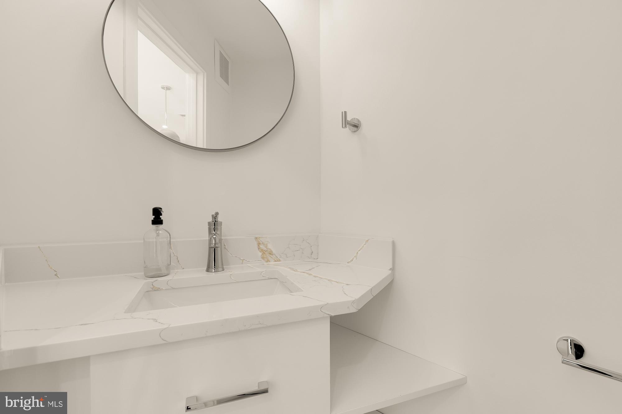 1850 Capitol Avenue Northeast Washington, DC 20002 - Photo 16 of 42 a bathroom with a sink and a mirror