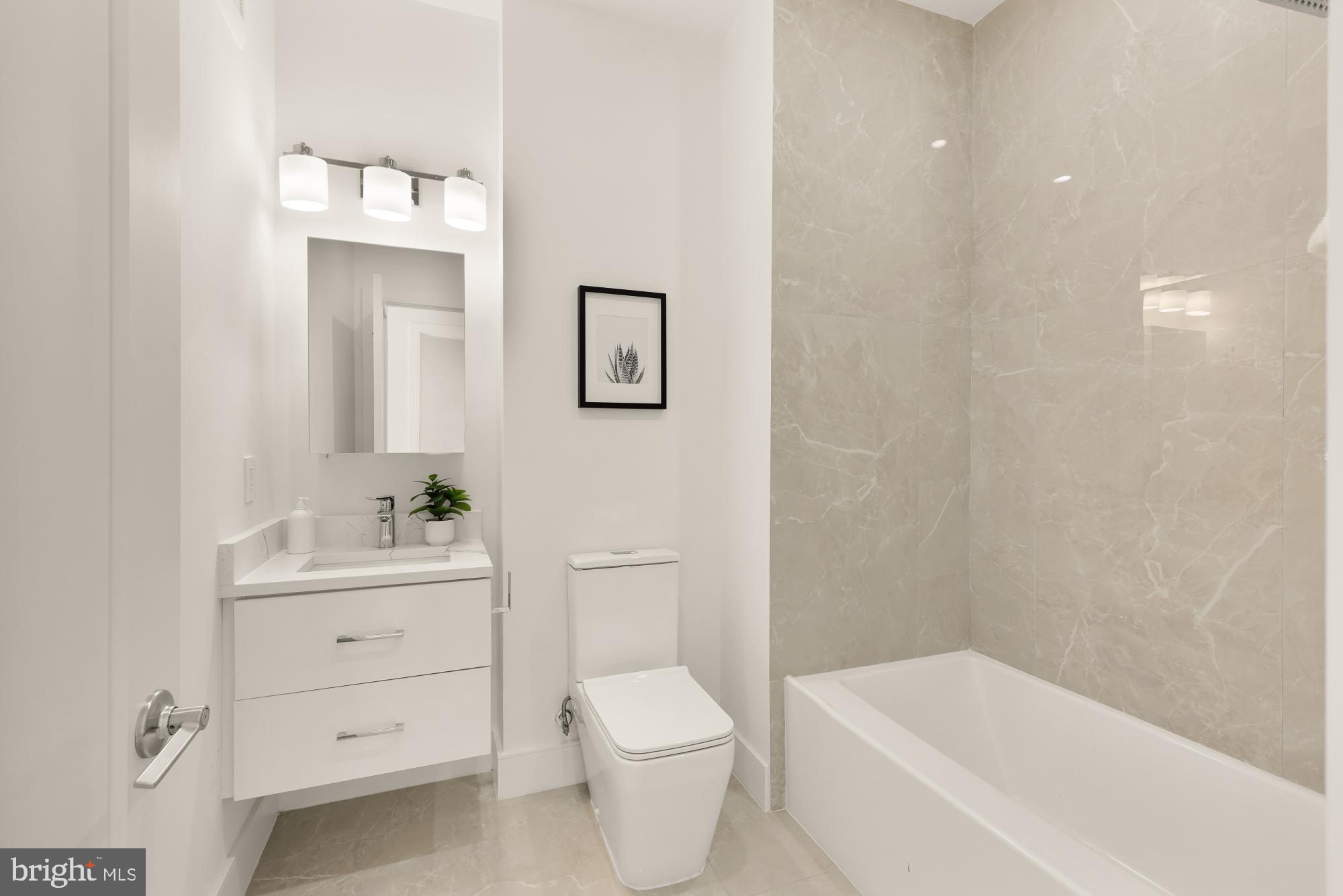 1850 Capitol Avenue Northeast Washington, DC 20002 - Photo 17 of 39 a bathroom with a sink a toilet and shower