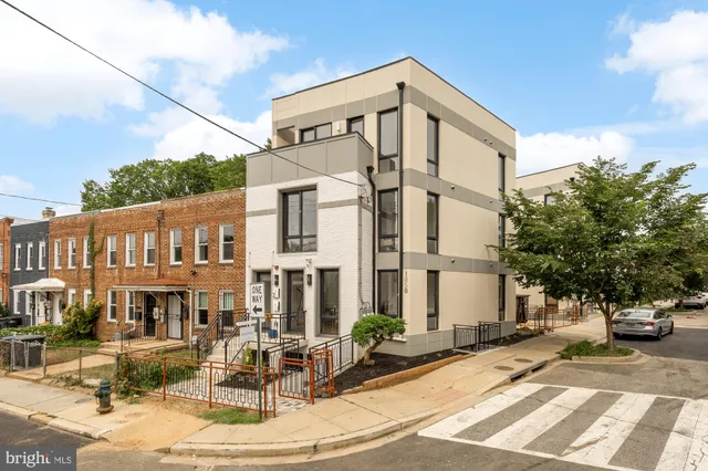 a outdoor living room with patio furniture and a potted plant