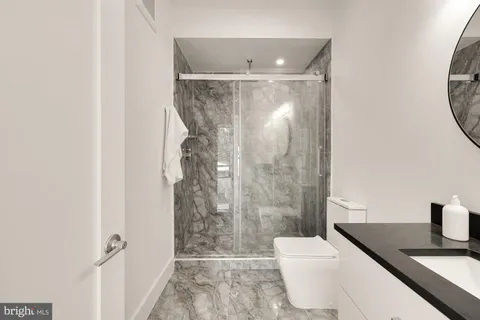 a view of balcony with a floor to ceiling window and brick wall