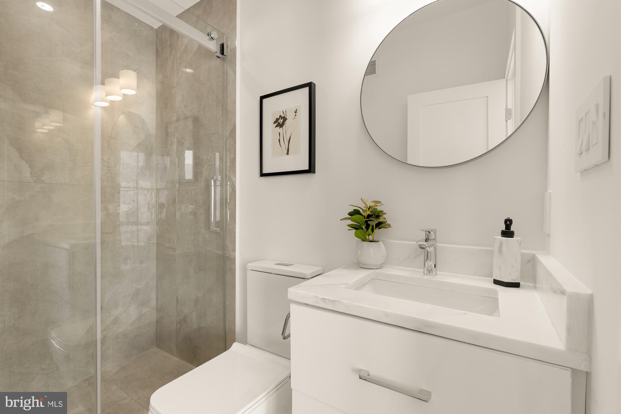 1850 Capitol Avenue Northeast Washington, DC 20002 - Photo 35 of 42 a bathroom with a sink a toilet and a mirror