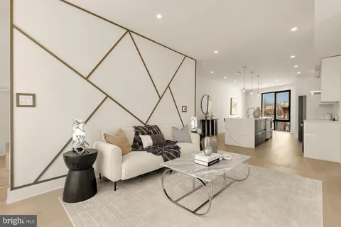 a large kitchen with kitchen island a stove a sink a refrigerator and a dining table with wooden floor