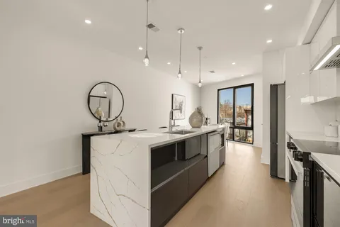 a dining room with furniture and a window