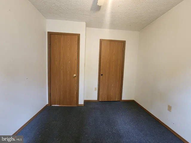 an empty room with closet area