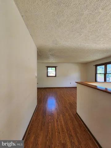 a view of a room with wooden floor and window