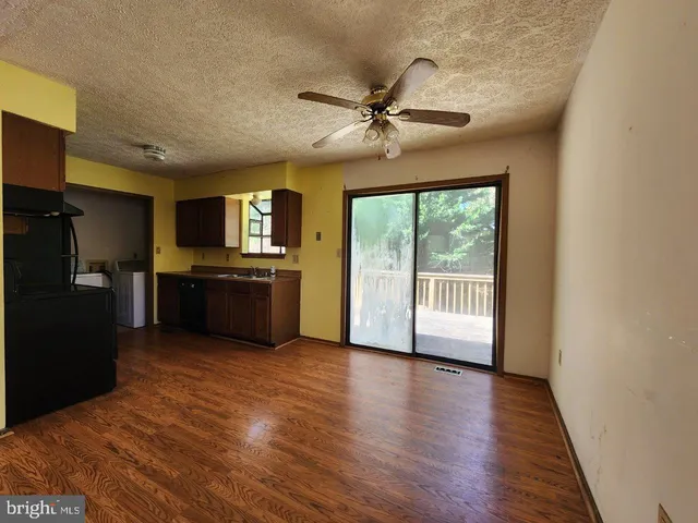 a view of a kitchen with a sink refrigerator and a window