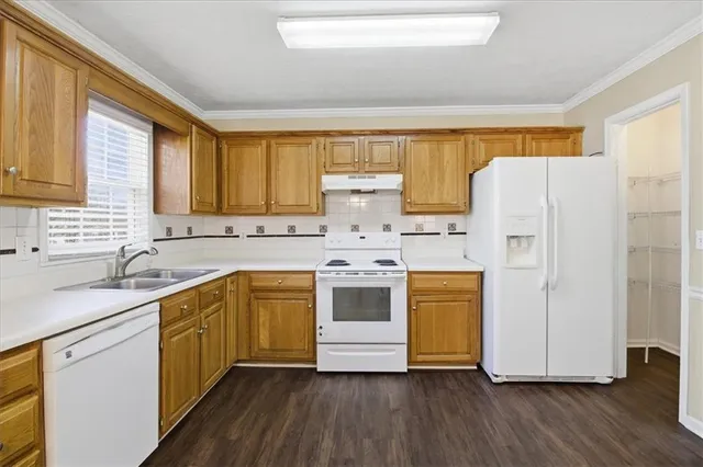 a kitchen with stainless steel appliances a white cabinets and sink