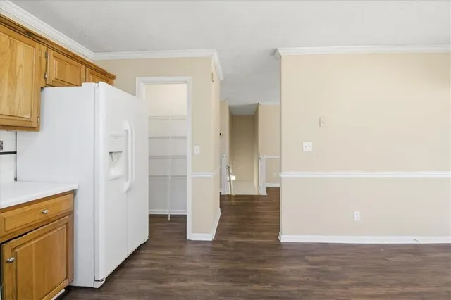 a view of a kitchen with a refrigerator and a stove