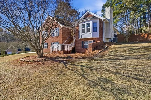 a front view of a house with a yard covered in snow