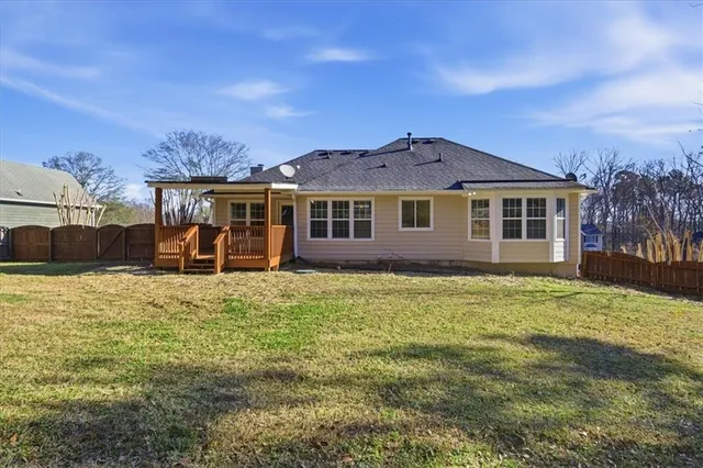 a backyard of a house with table and chairs