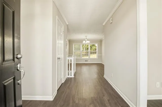 a view of hallway with wooden floor