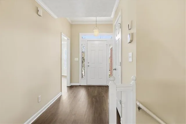an empty room with wooden floor and a window