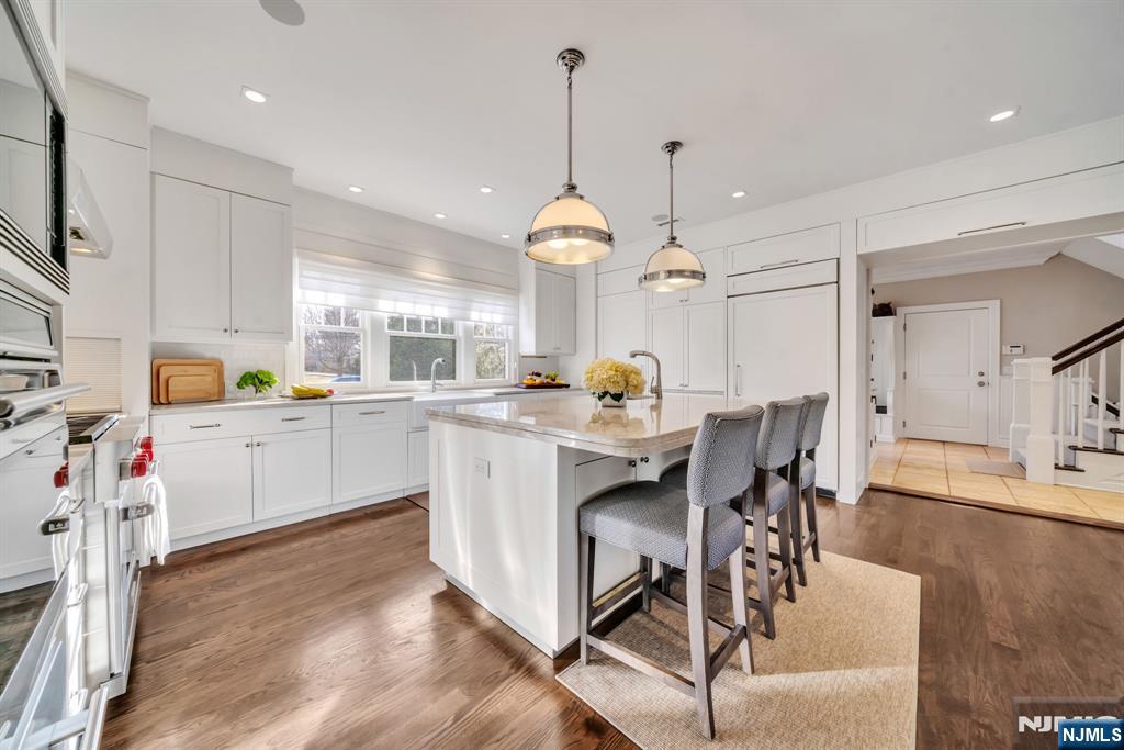 187 Buckingham Road Tenafly, NJ 07670 - Photo 19 of 50 a kitchen with a dining table chairs sink and cabinets