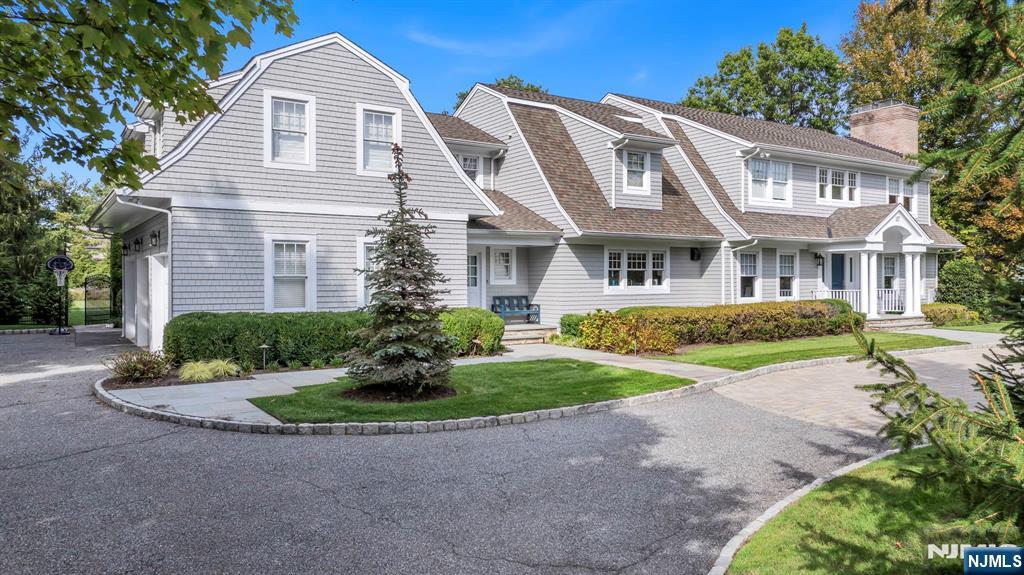 187 Buckingham Road Tenafly, NJ 07670 - Photo 2 of 50 a front view of a house with a yard and potted plants