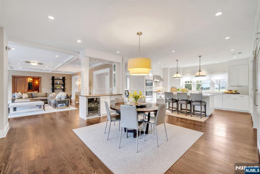 187 Buckingham Road Tenafly, NJ 07670 - Photo 22 of 50 an open kitchen with dining table and wooden floors