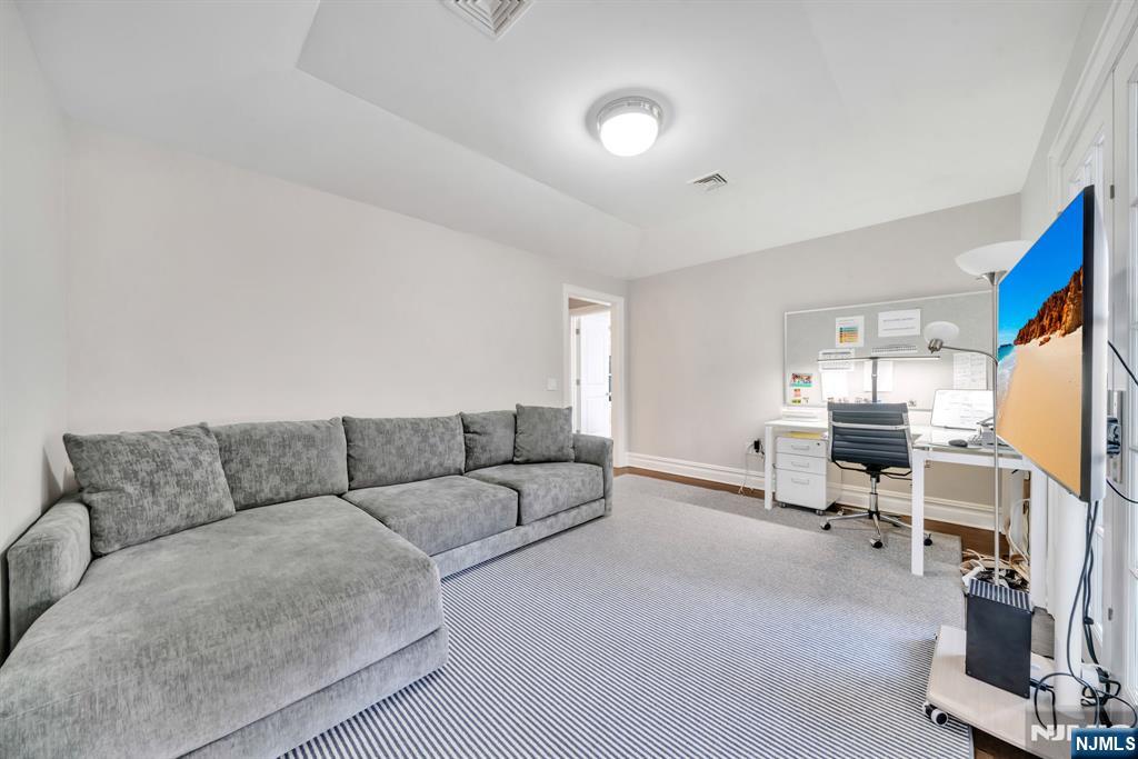 187 Buckingham Road Tenafly, NJ 07670 - Photo 24 of 50 a living room with furniture and a flat screen tv