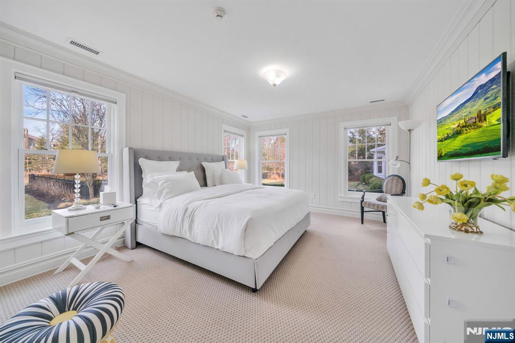 187 Buckingham Road Tenafly, NJ 07670 - Photo 26 of 50 a spacious bedroom with a bed and a flat screen tv