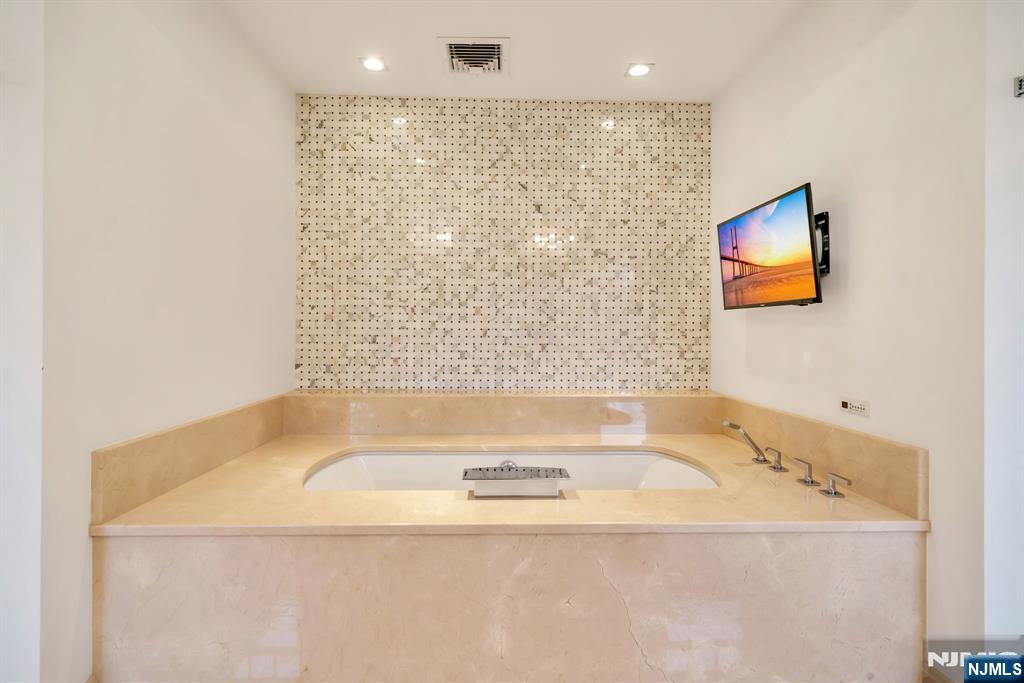 187 Buckingham Road Tenafly, NJ 07670 - Photo 31 of 50 a bathroom with a bathtub and a shower