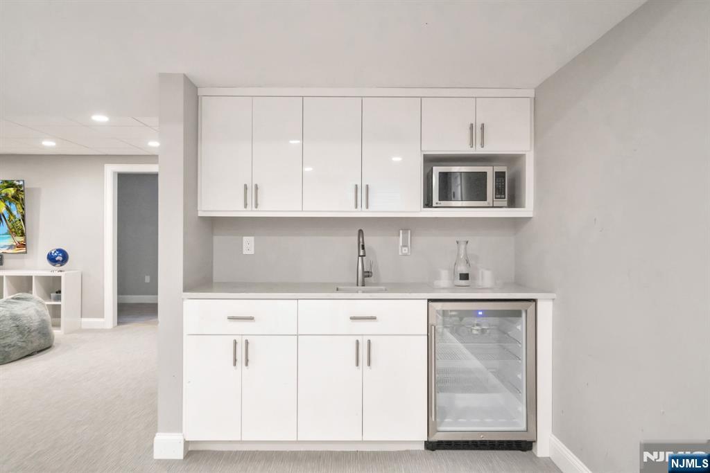 187 Buckingham Road Tenafly, NJ 07670 - Photo 44 of 50 a kitchen with white cabinets and sink