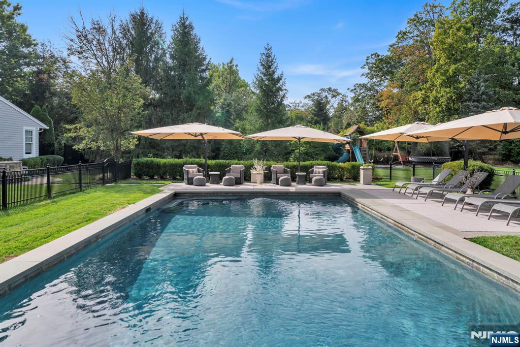 187 Buckingham Road Tenafly, NJ 07670 - Photo 5 of 50 a view of a swimming pool with sitting area and furniture