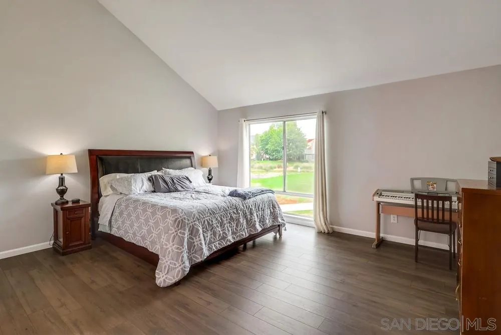 23667 Country Villa Road Ramona, CA 92065 - Photo 12 of 25 a bedroom with a bed and wooden floor