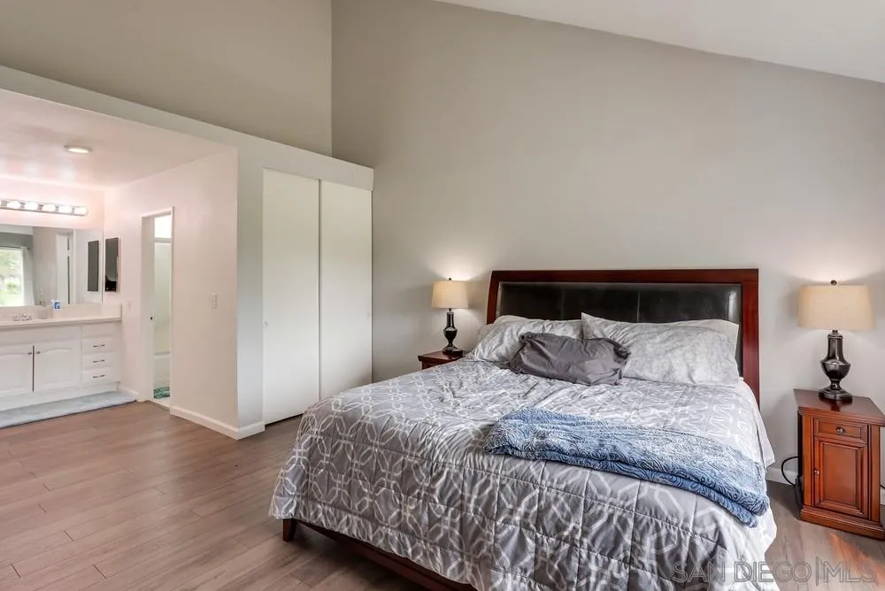 23667 Country Villa Road Ramona, CA 92065 - Photo 13 of 25 a bedroom with a bed and closet with wooden floor