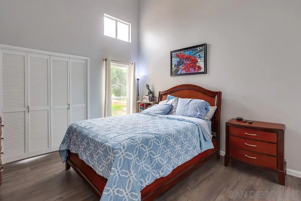23667 Country Villa Road Ramona, CA 92065 - Photo 15 of 25 a bedroom with a bed and a cabinet