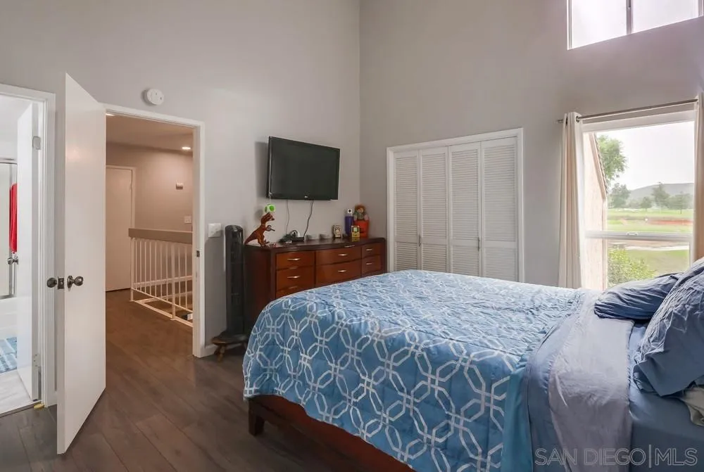23667 Country Villa Road Ramona, CA 92065 - Photo 16 of 25 a bedroom with a bed and a flat screen tv