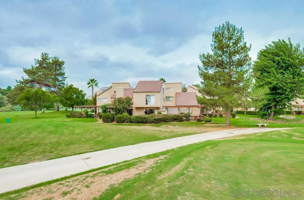 23667 Country Villa Road Ramona, CA 92065 - Photo 21 of 25 a view of a big house with a big yard and potted plants and large trees