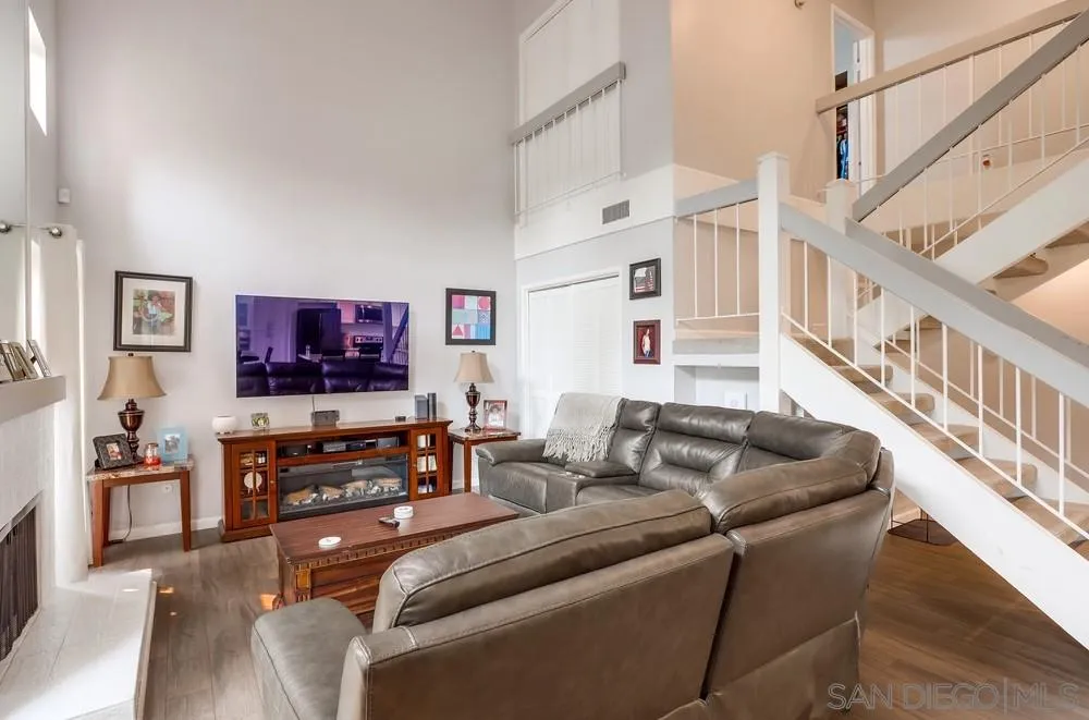 23667 Country Villa Road Ramona, CA 92065 - Photo 6 of 25 a living room with furniture a flat screen tv and a wooden floor