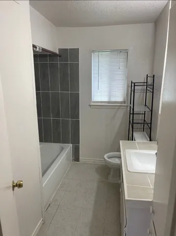 a bathroom with a bathtub sink and toilet