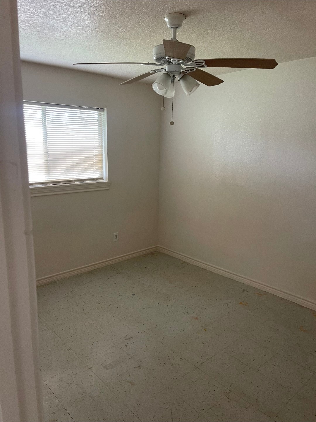 411 Tennessee Street, Unit 6 Houston, TX 77029 - Photo 5 of 5 an empty room with a window and a fan