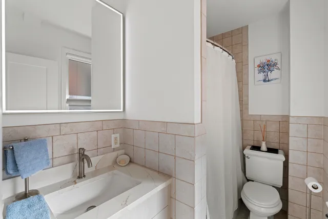 a view of a room with furniture and wooden floor