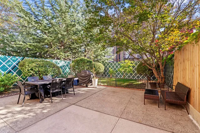 a view of balcony with wooden floor and fence