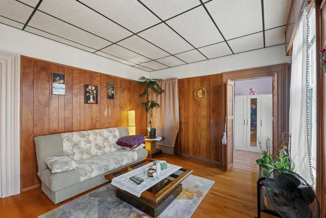 a bedroom with a bed a mirror and a window