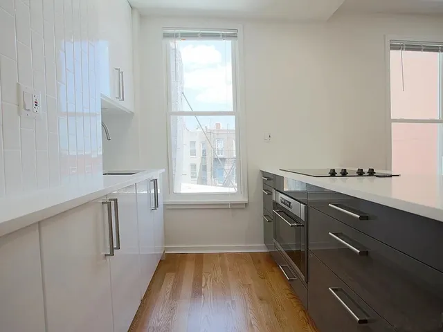 a bathroom with a sink shower and a mirror