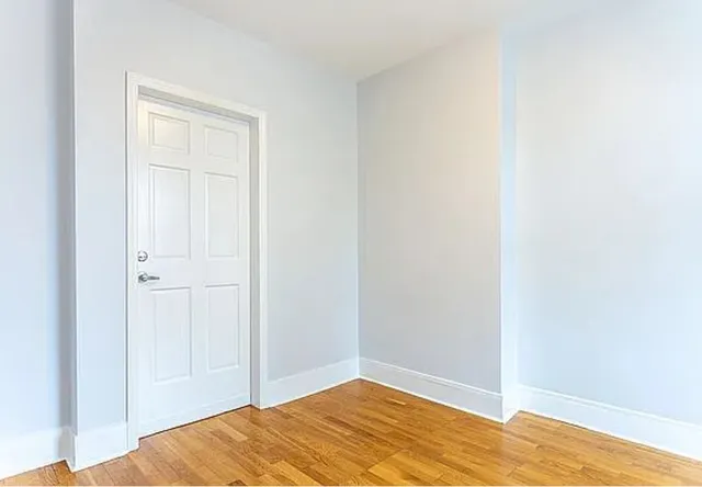 a room with a window and wooden floor