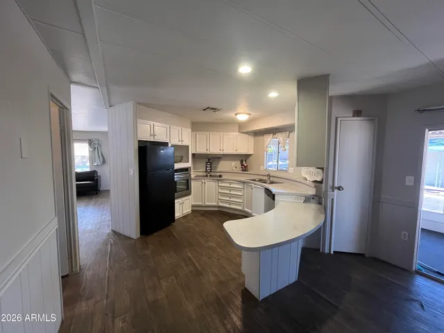 a kitchen with a refrigerator and a sink