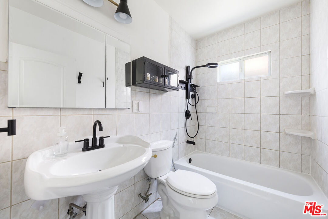 3922 Edison Walk Los Angeles, CA 90032 - Photo 12 of 26 a bathroom with a sink a toilet and shower