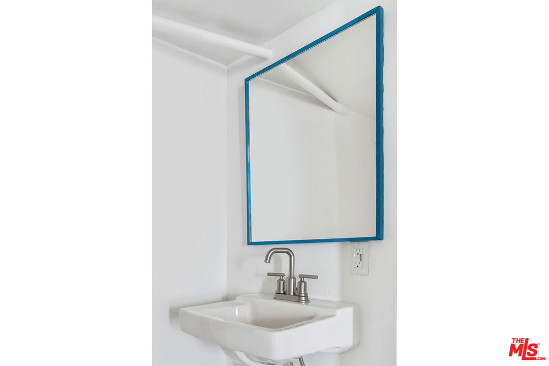 3922 Edison Walk Los Angeles, CA 90032 - Photo 19 of 26 a bathroom with a sink and a mirror