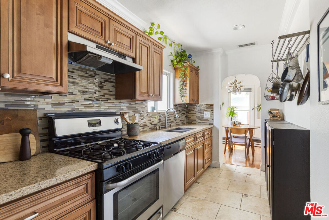 3922 Edison Walk Los Angeles, CA 90032 - Photo 8 of 26 a kitchen with granite countertop a stove and a sink