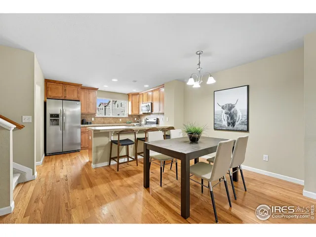 a view of a dining room with furniture and a chandelier