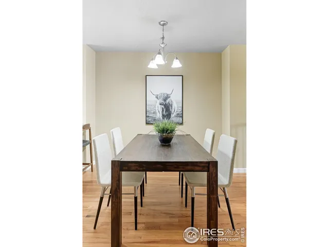 a view of a dining room with a table and chairs