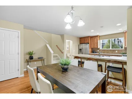 a kitchen with kitchen island a table and chairs in it